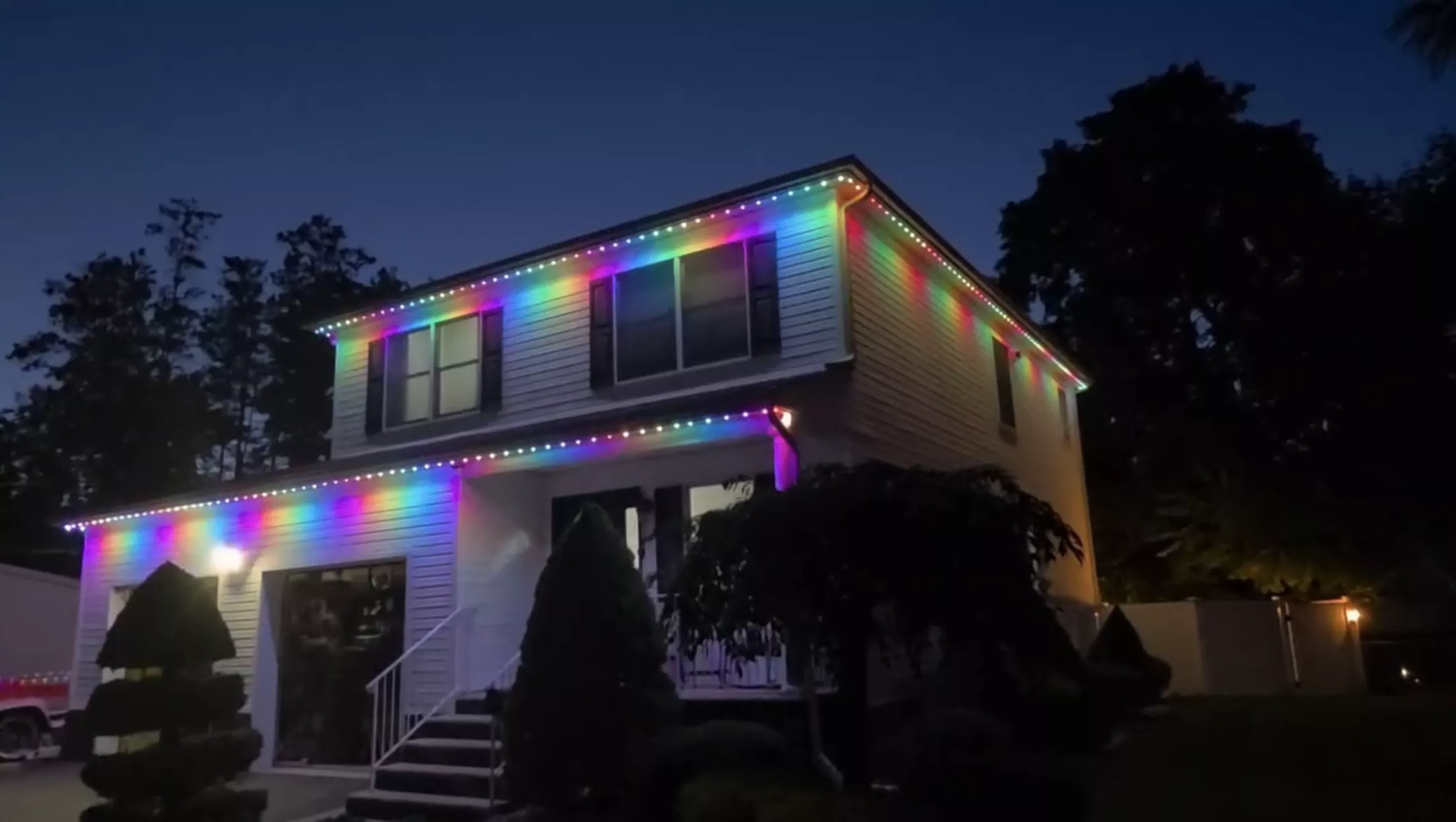 Home lit in rainbow colors at night