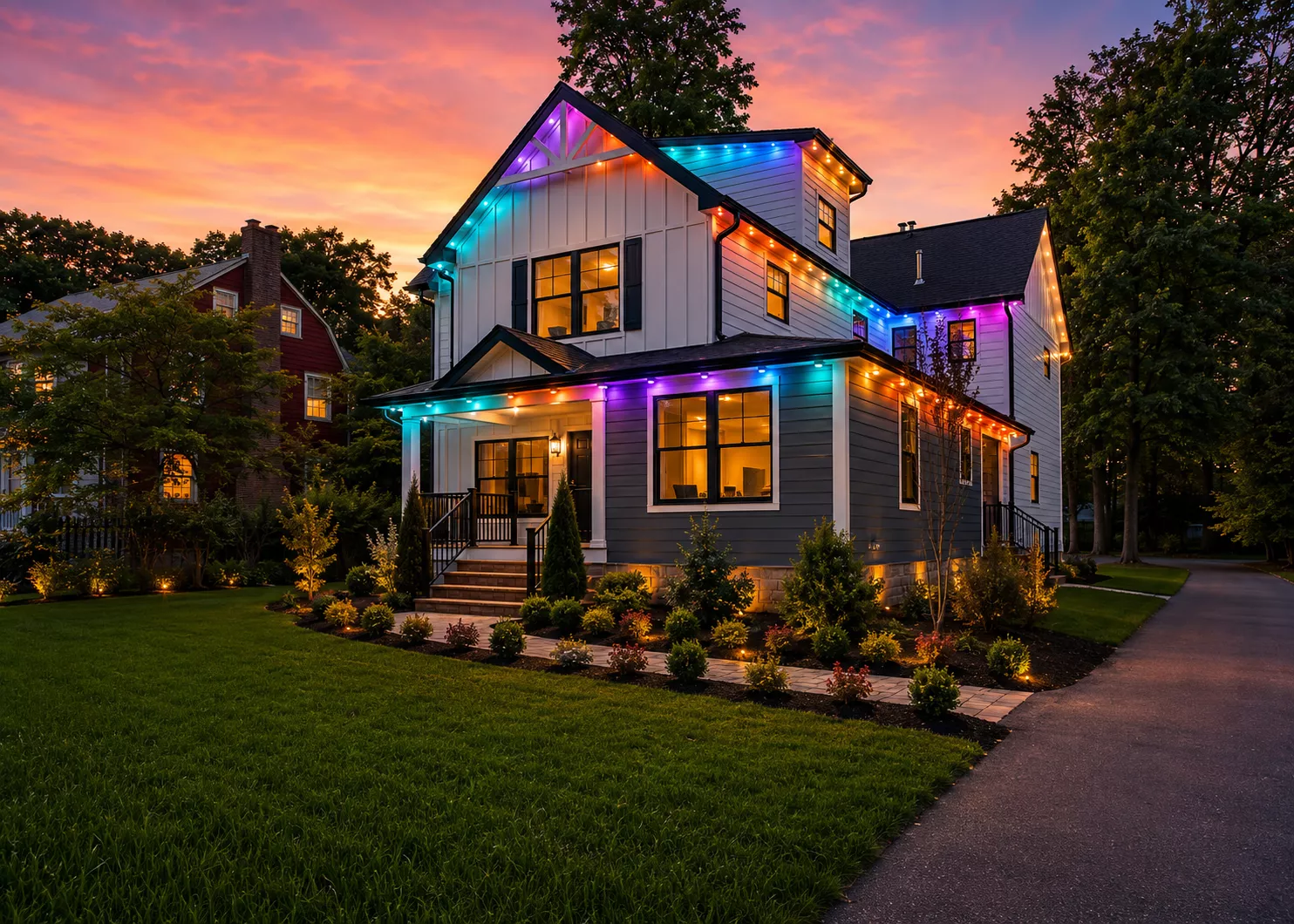 Craftsman home with rainbow roofline lights at sunset